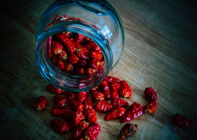 Dried Chillies in a glass jar still life, dried chillies, glass jar, food photography, still life photo of dried chillies, still life photography, red chilli spice
